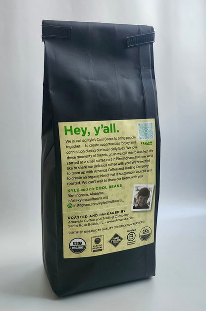 A picture of the left rear of the coffee bag. Above the quality stamps there is a picture of Kyle on the label, Kyle is smiling!