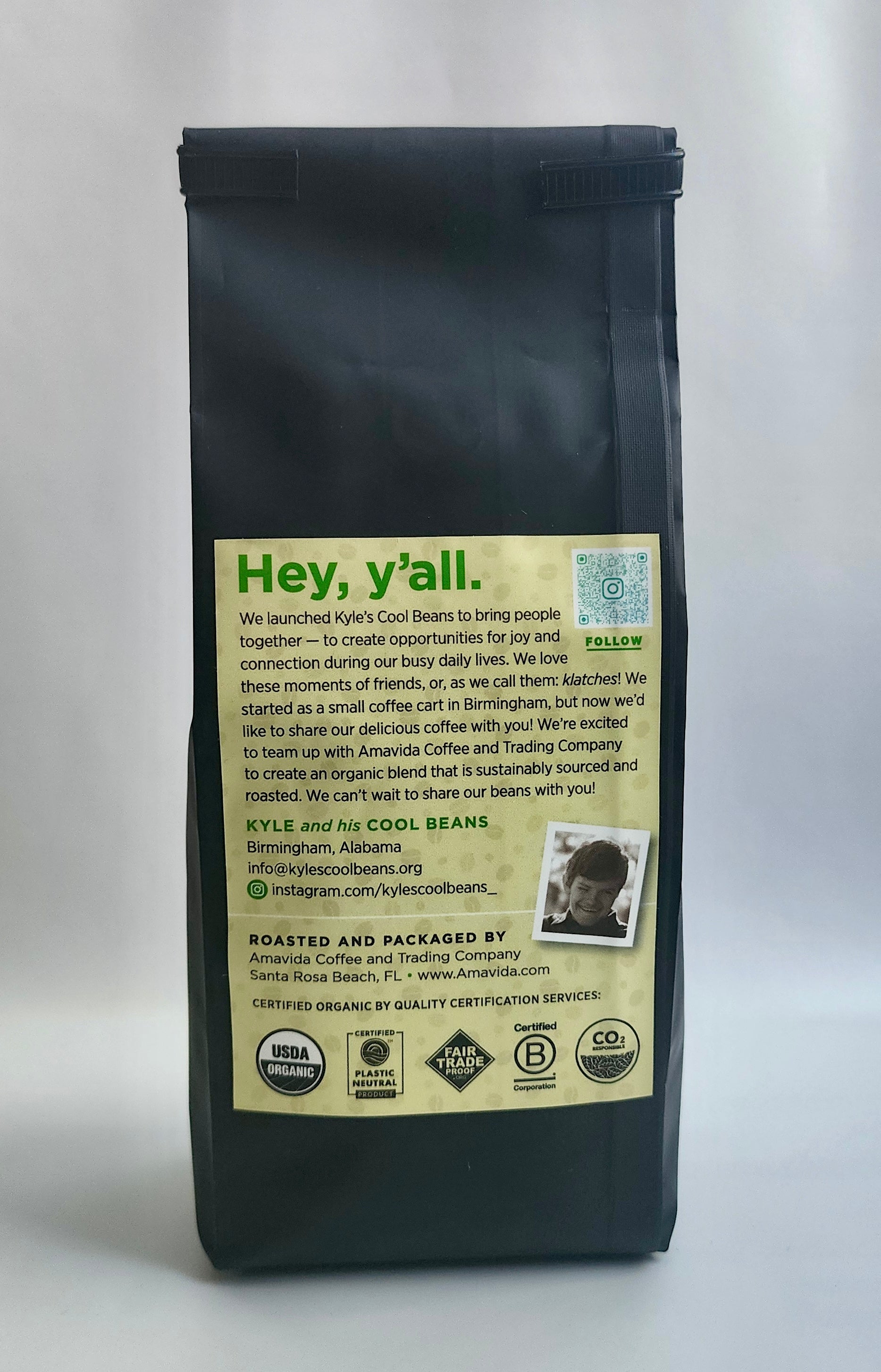 A picture of the back of the coffee bag. There is a label on the back and it highlights the quality of the coffee. There are; USDA Organic, plastic neutral, Fair Trade, Certified B Corp, and a CO2 responsible stamps on the label.